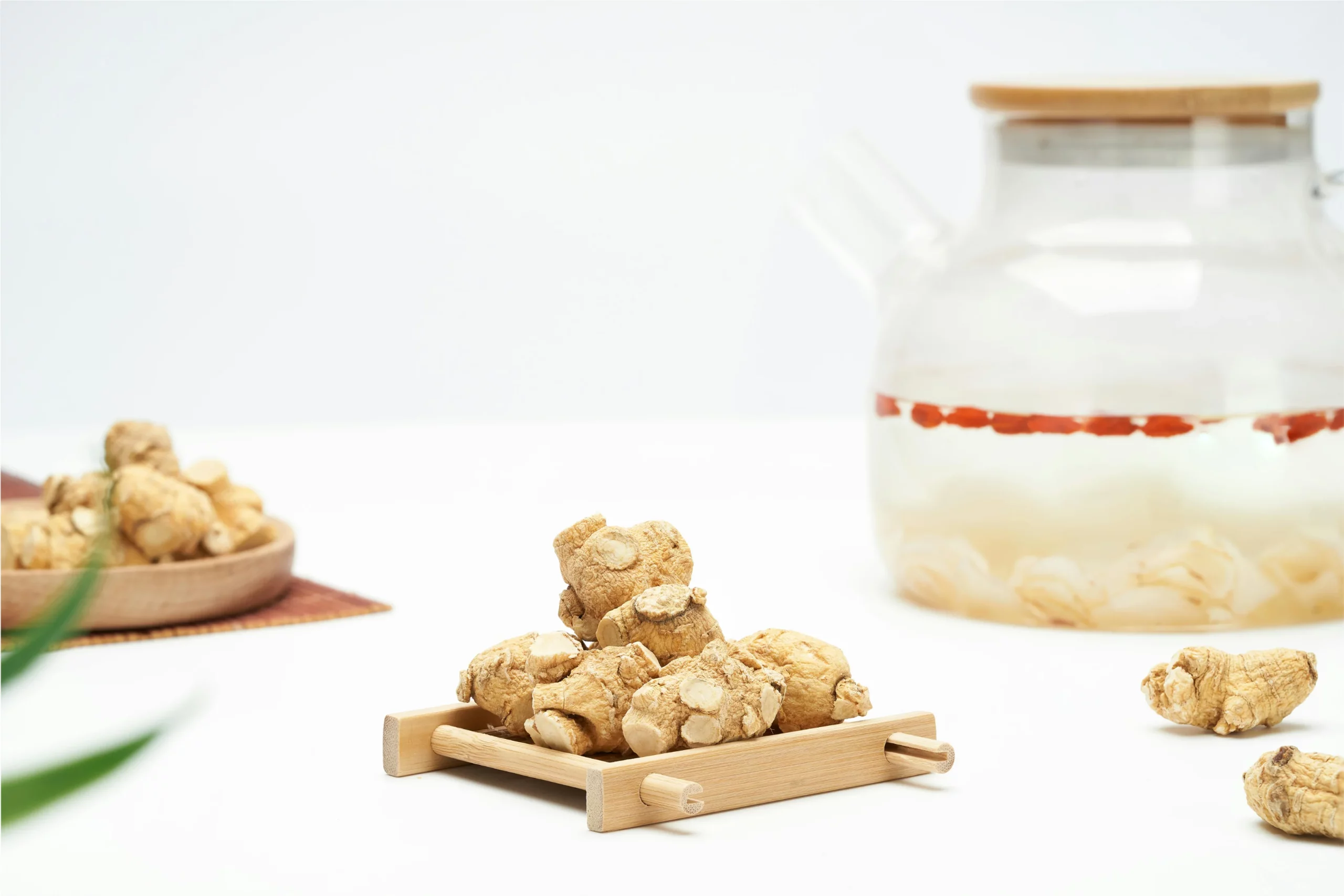 Ginseng roots and herbal tea on table.