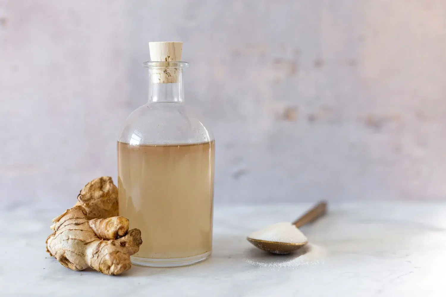 Bottle of ginger vinegar with sugar and ginger.