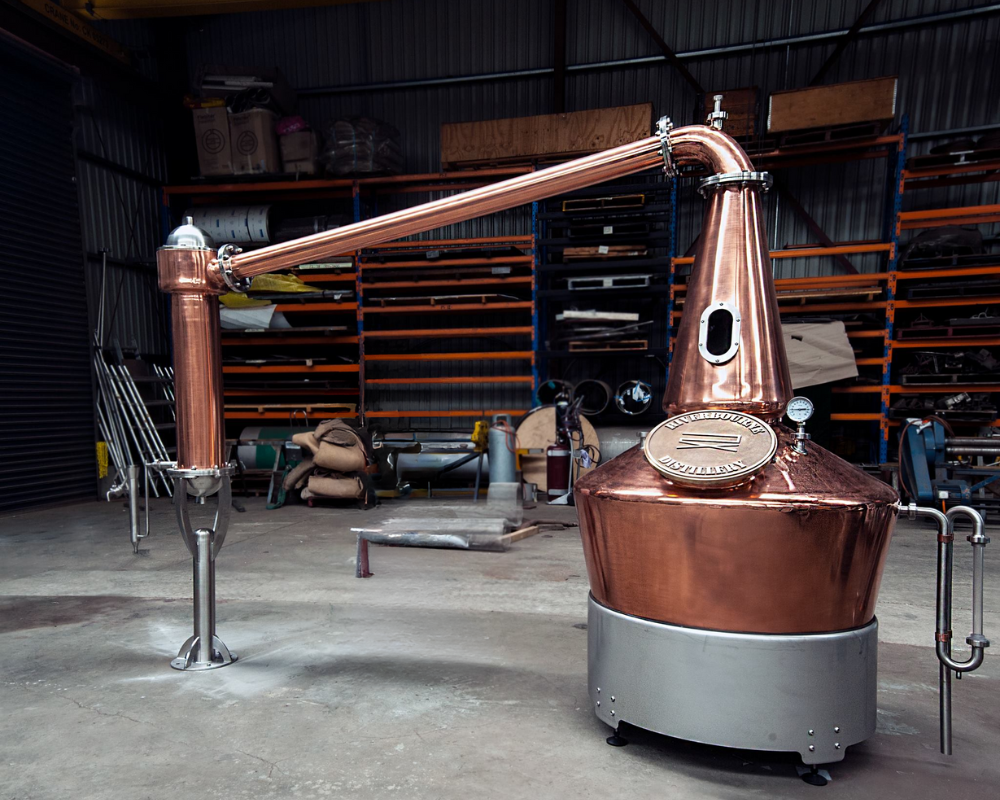 Copper distillation equipment in a warehouse.