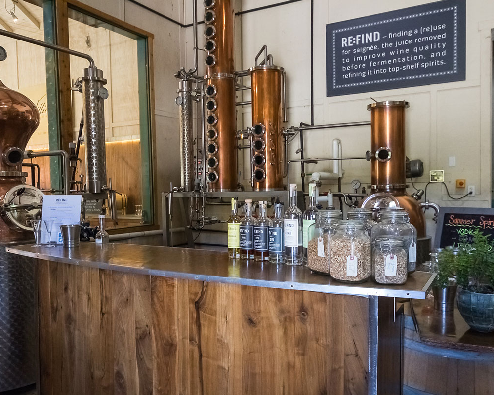 Distillery with bottles and copper stills.