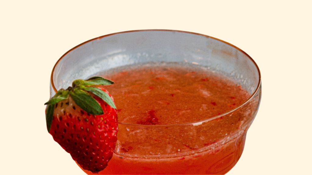 Strawberry cocktail with a fresh strawberry garnish.